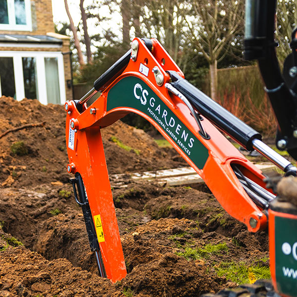 Digging trench in Weybridge for garden landscaping project