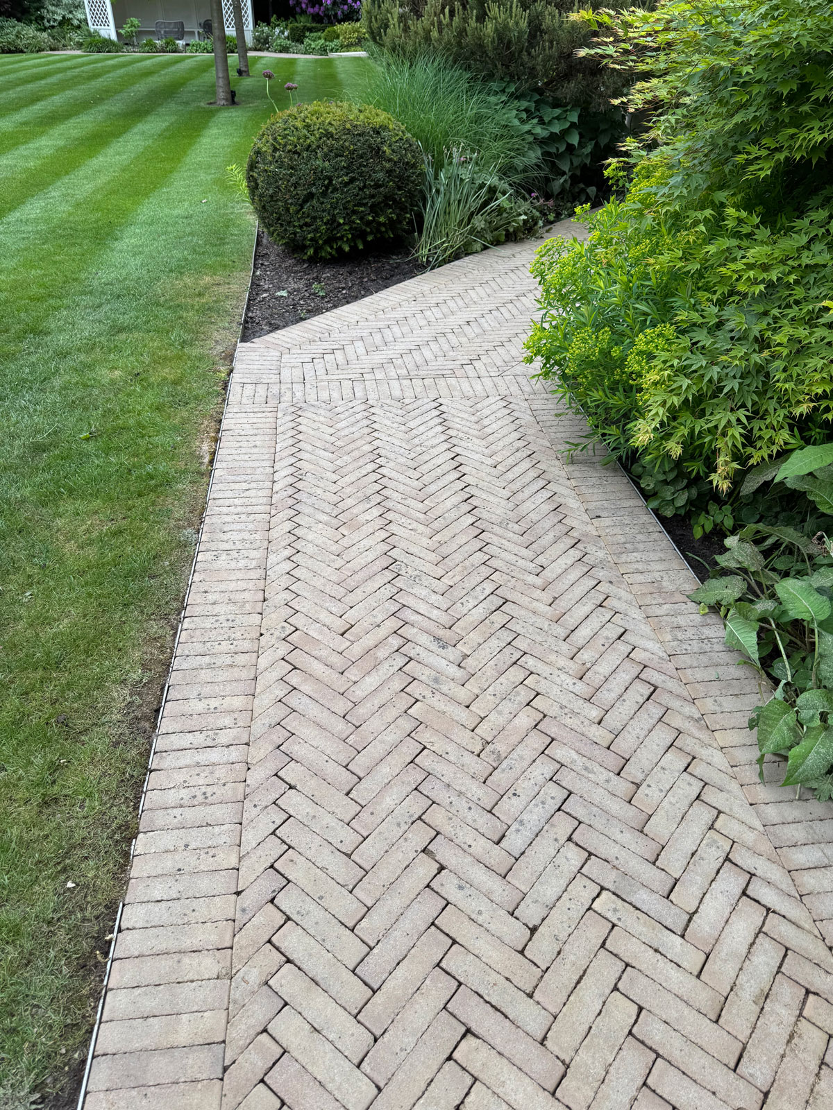 Jet washing herringbone brick path