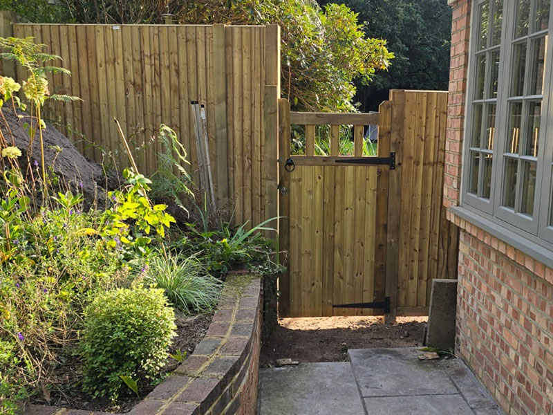 Close slatted fencing installation in Cobham